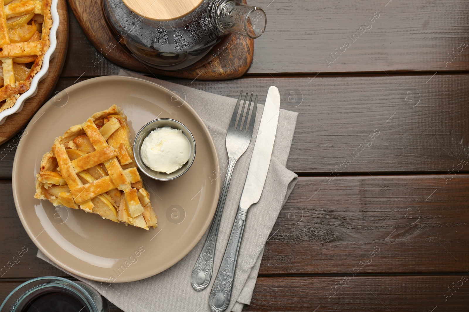 Photo of Piece of tasty homemade quince pie served on wooden table, flat lay. Space for text