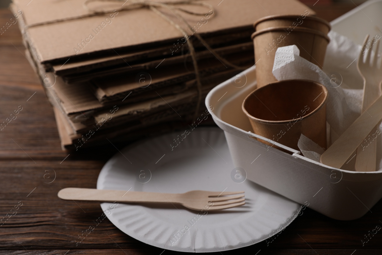 Photo of Heap of waste paper on wooden table, closeup