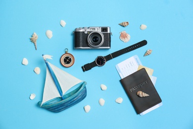 Flat lay composition with camera, passport and exotic seashells on color background. Professional photography