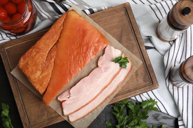 Photo of Flat lay composition with delicious smoked bacon on table