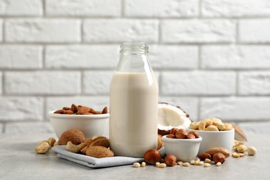 Photo of Vegan milk and different nuts on light table