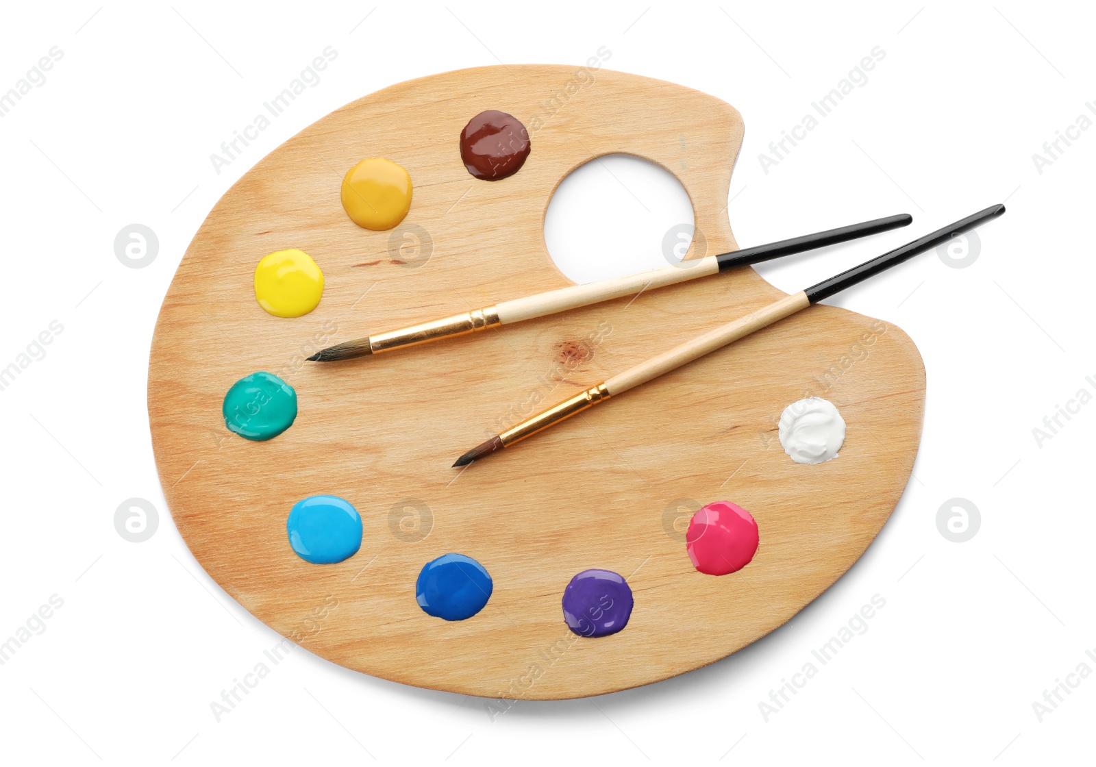 Photo of Palette with paints and brushes on white background, top view