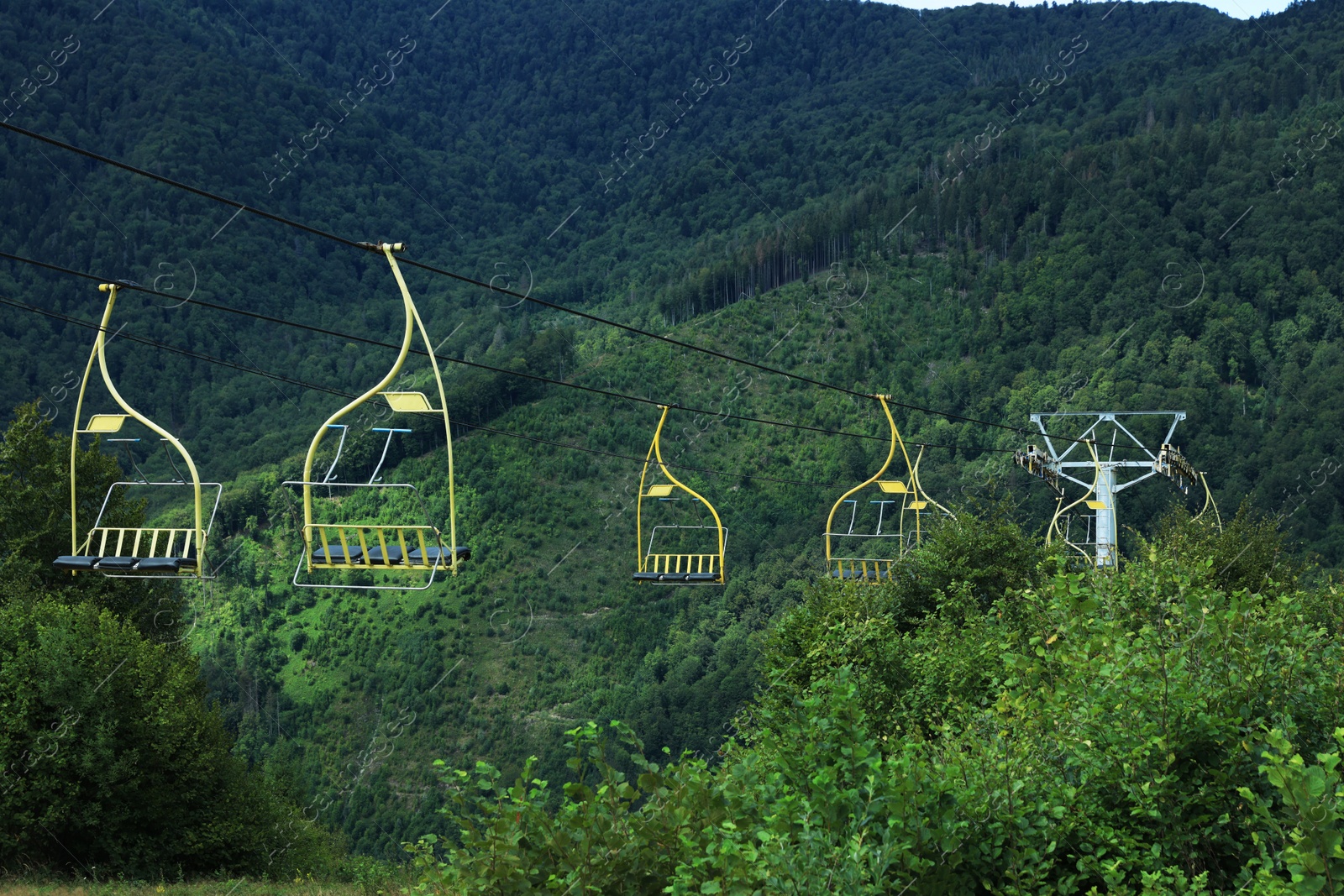 Photo of Chairlift with seats at beautiful mountain resort