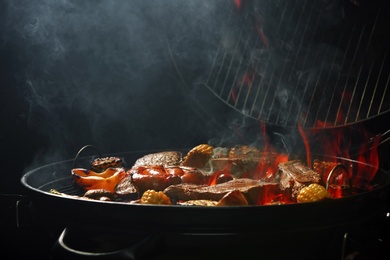 Photo of Assorted delicious meat and vegetables on barbecue grill