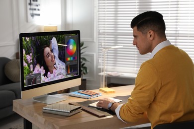 Professional retoucher working on computer in office