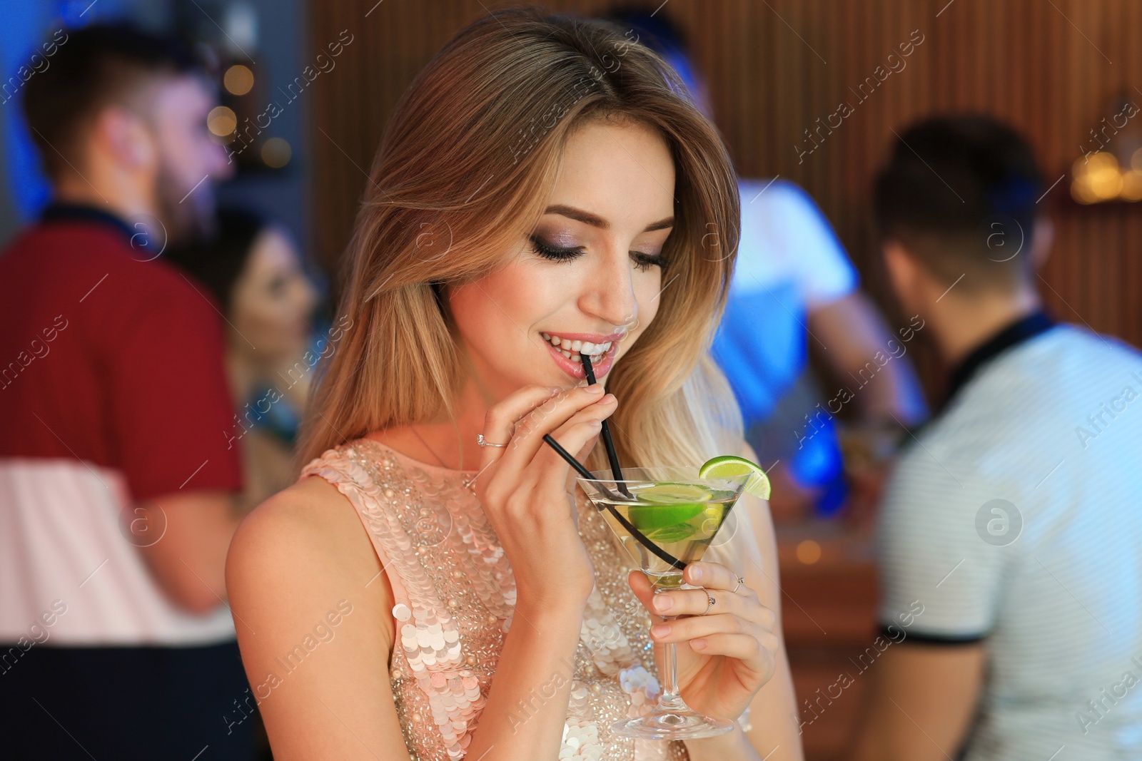 Photo of Beautiful young woman with glass of martini cocktail in bar