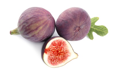 Photo of Whole and cut purple figs on white background, top view