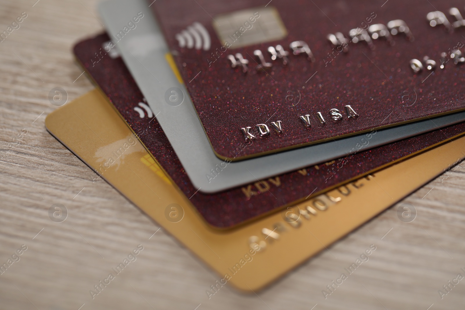 Photo of Many credit cards on beige background, closeup view