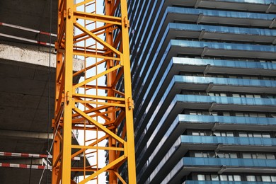 Photo of Construction site with tower crane near buildings
