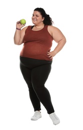 Happy overweight woman with apple on white background