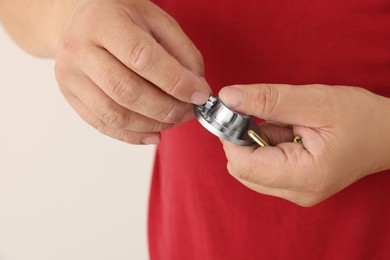 Photo of Worker holding screw and pipe fitting for installation, closeup