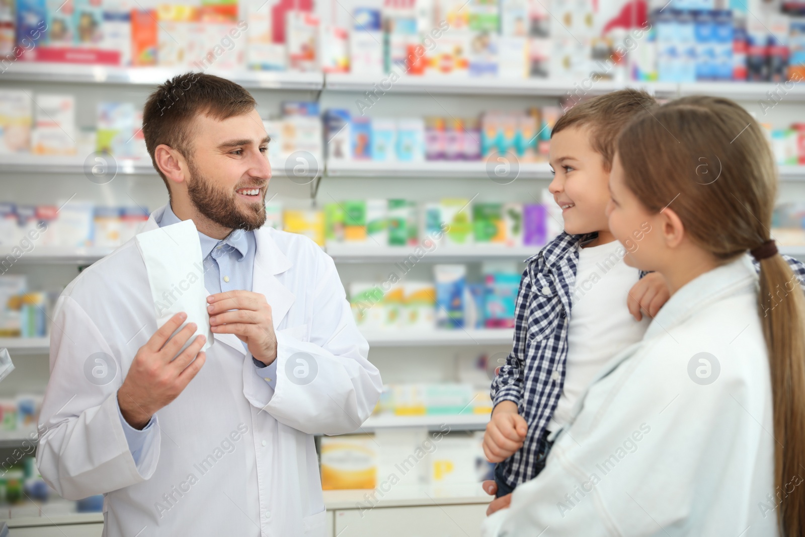 Image of Professional pharmacist working with customer in modern drugstore