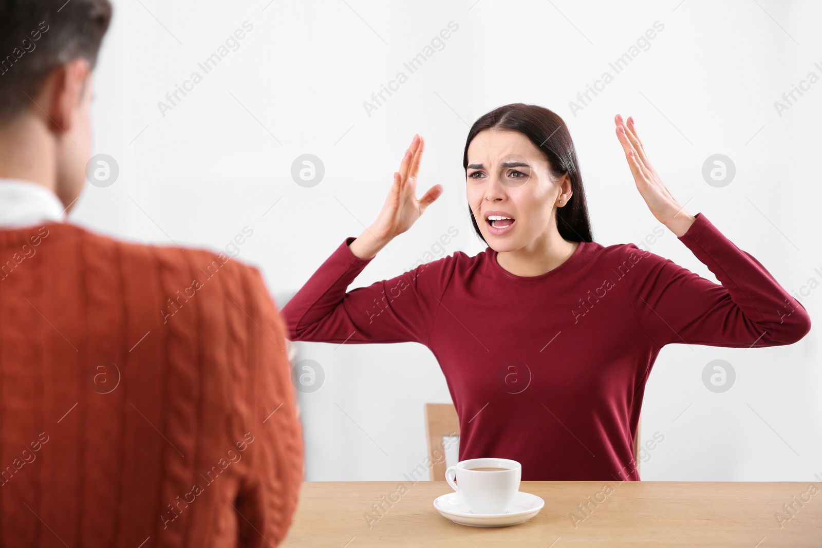 Photo of Couple having quarrel in cafe. Relationship problems