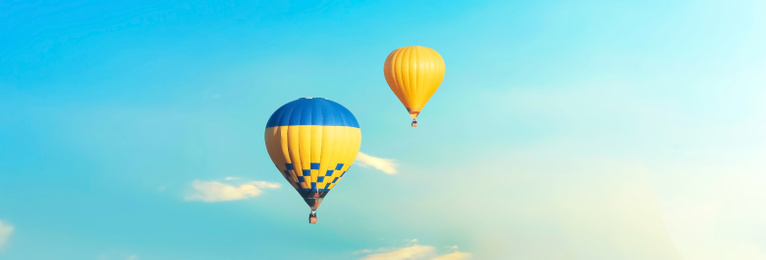 Hot air balloons in blue sky. Banner design 