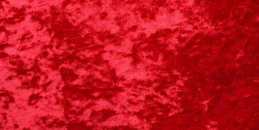 Photo of Texture of red velvet fabric as background, top view