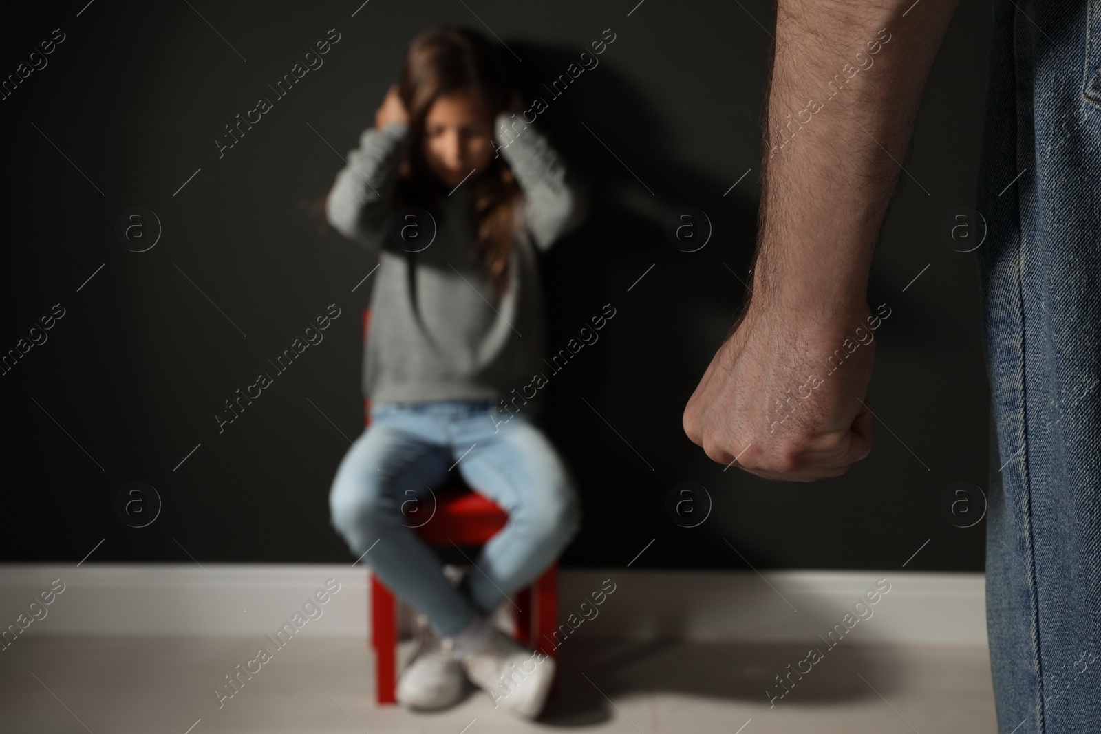 Photo of Man threatening his daughter indoors, closeup. Domestic violence concept