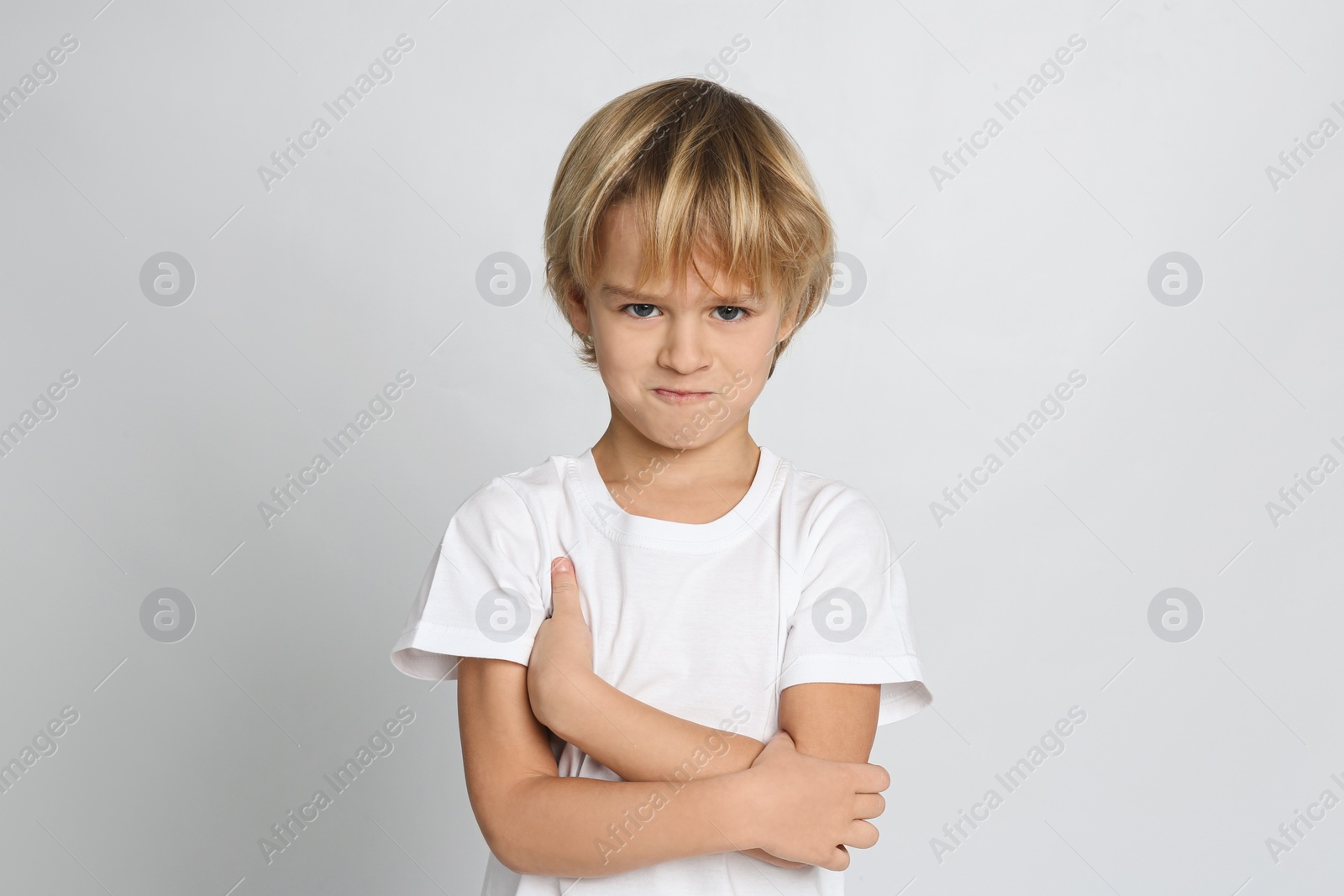 Photo of Portrait of cute little boy on light grey background