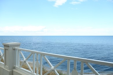 Photo of Simple white balustrade near beautiful tranquil sea