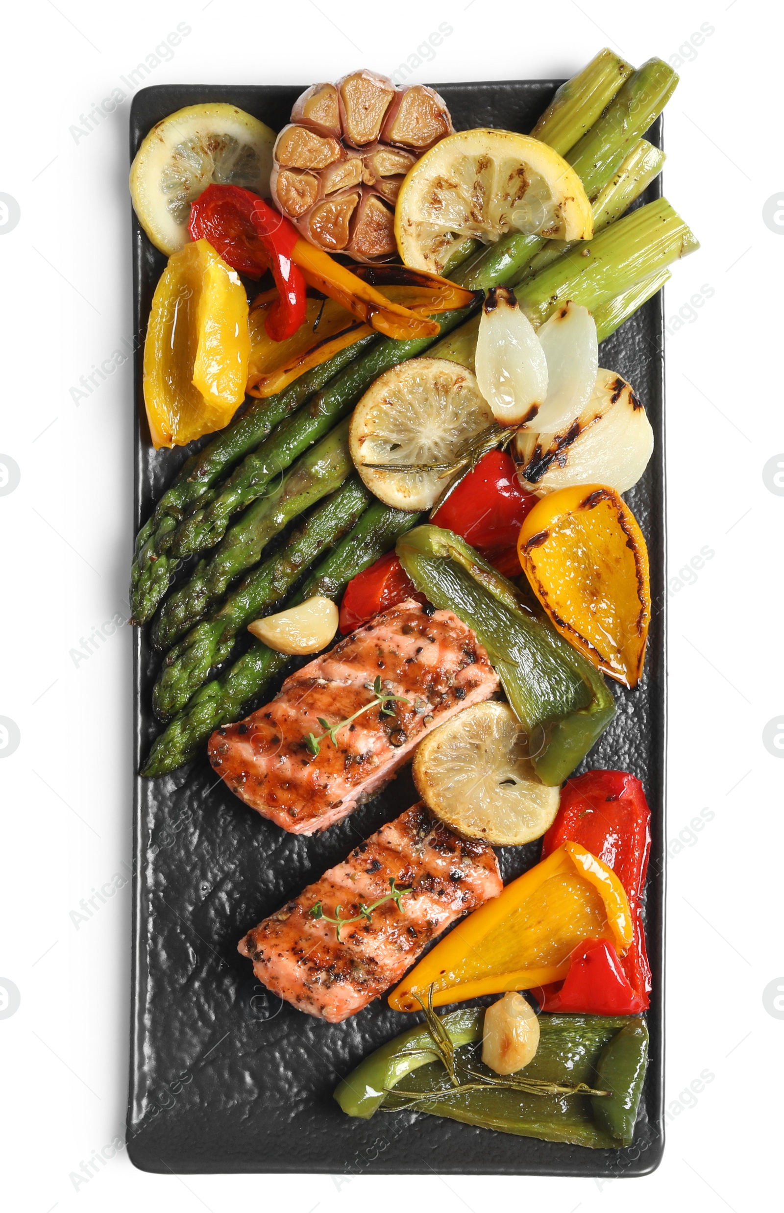 Photo of Tasty grilled salmon with lemon and vegetables on white background, top view