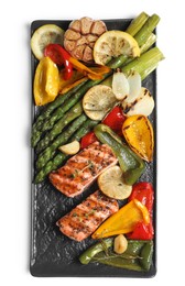 Tasty grilled salmon with lemon and vegetables on white background, top view