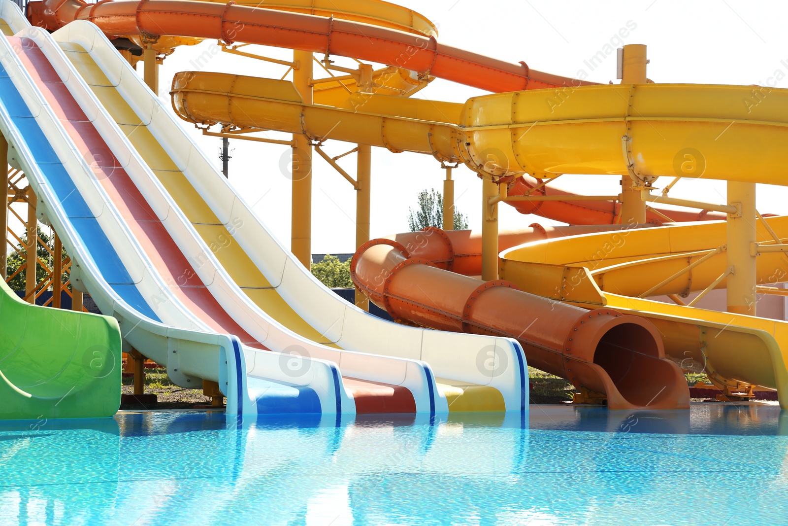 Photo of Different colorful slides in water park on sunny day