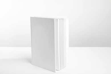 Photo of Book with blank cover on white background