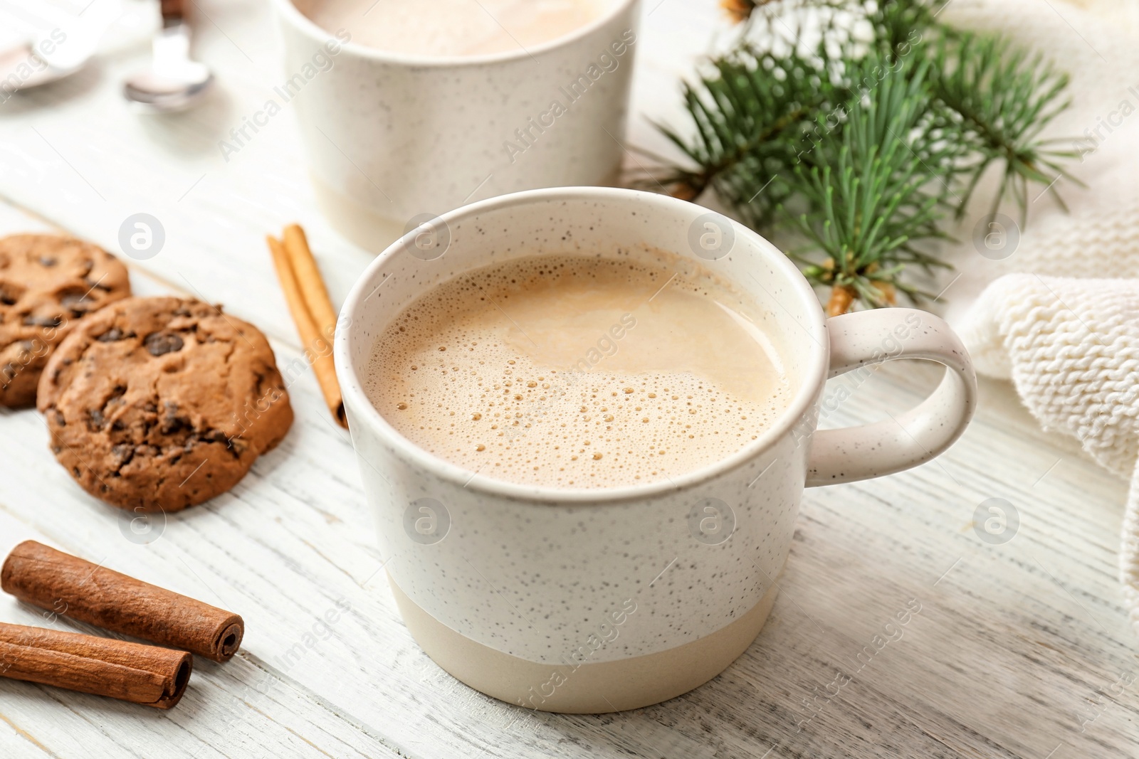 Photo of Cup with delicious hot cocoa drink on wooden table
