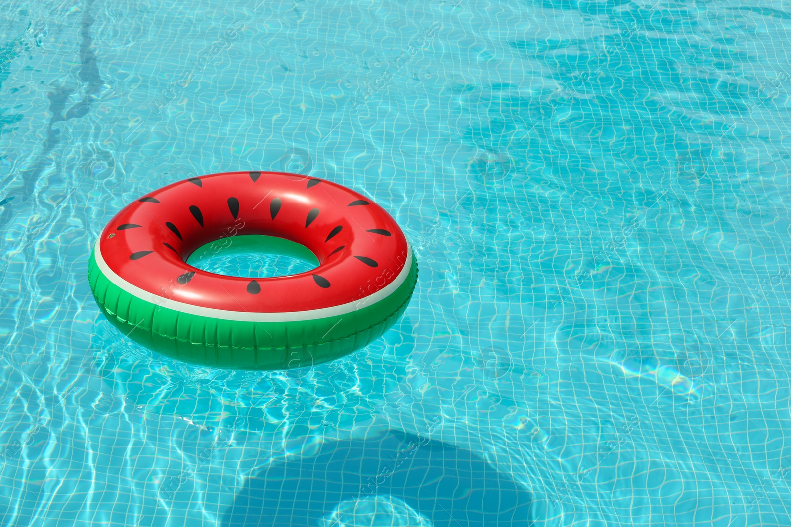 Photo of Inflatable ring floating in pool on sunny day