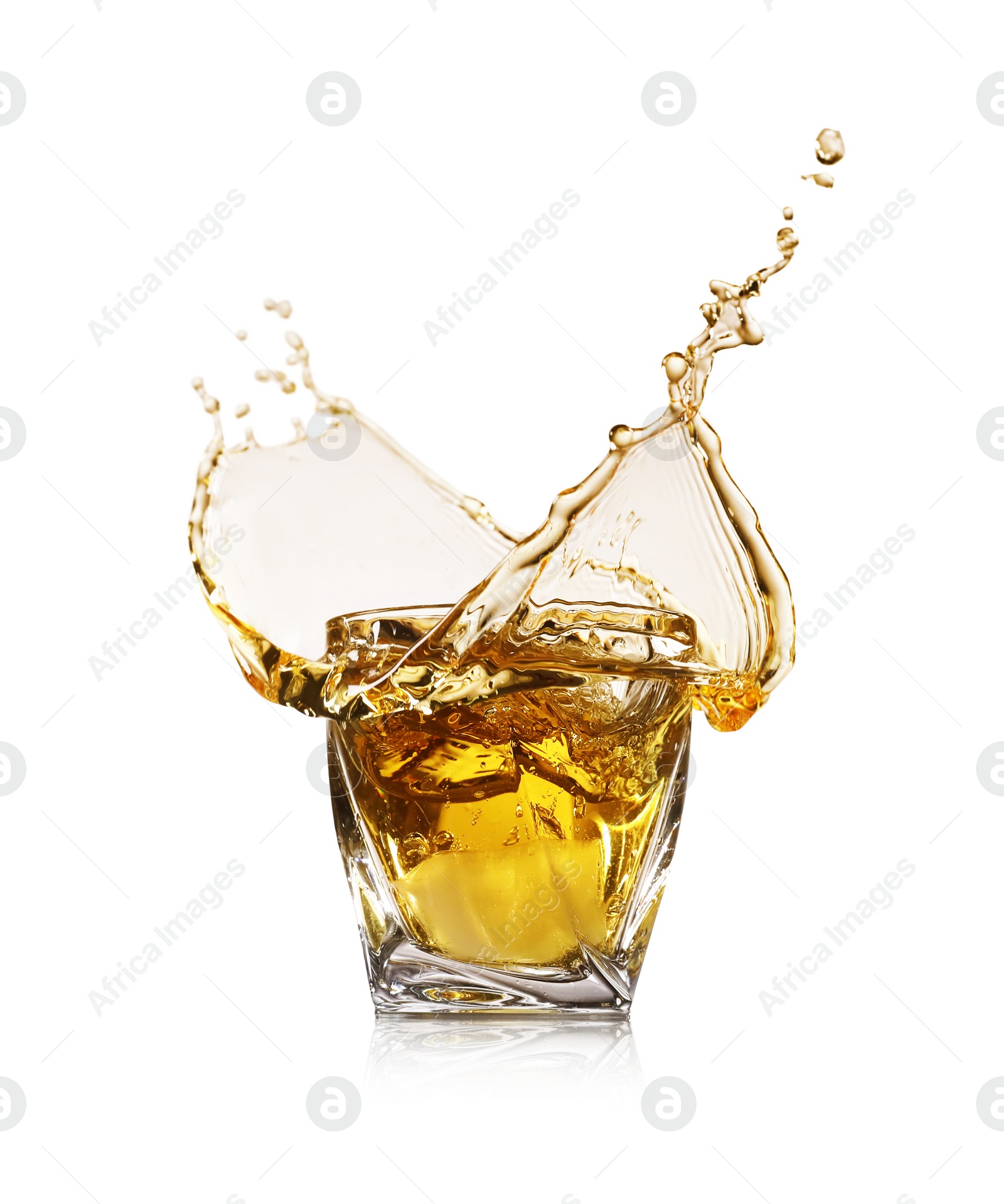 Photo of Whiskey splashing in glass on white background