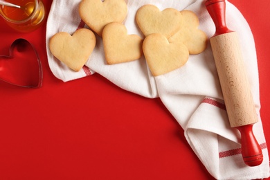 Flat lay composition with heart shaped cookies and space for text on color background