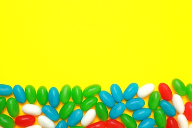 Photo of Flat lay composition with jelly beans on color background. Space for text