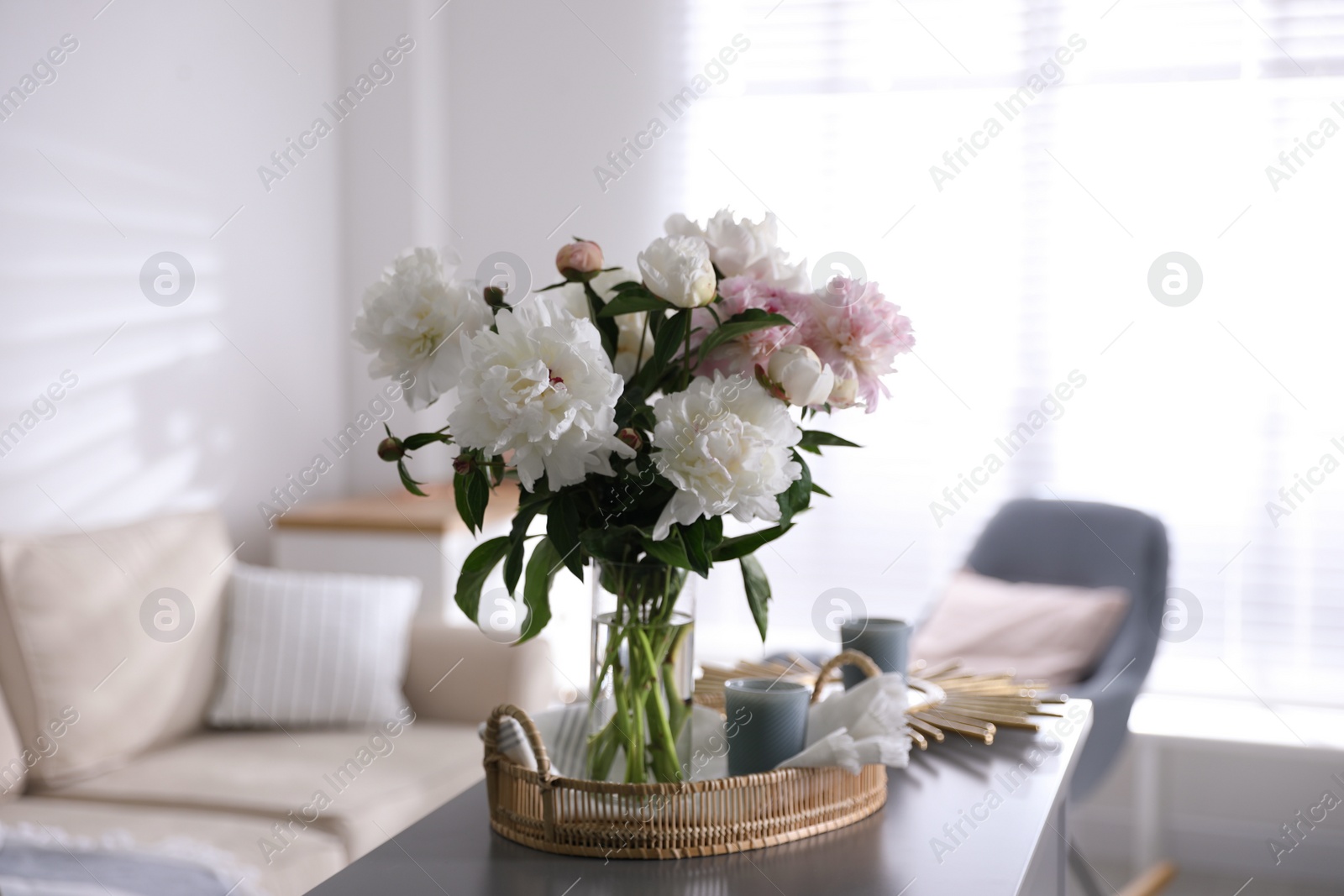 Photo of Bouquet of beautiful peony flowers on table indoors