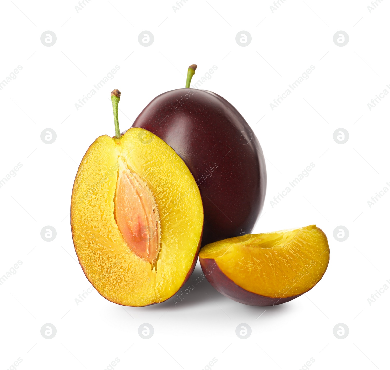 Photo of Whole and cut ripe plums on white background