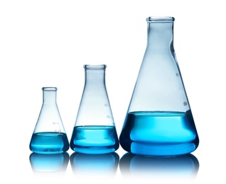 Photo of Conical flasks with liquid on table against color background. Laboratory analysis