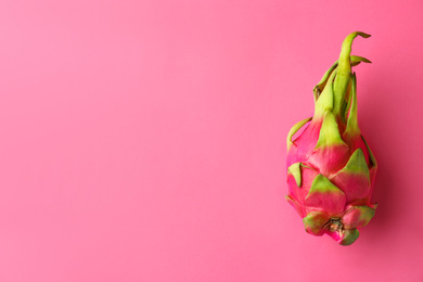 Delicious ripe dragon fruit (pitahaya) on pink background, top view. Space for text