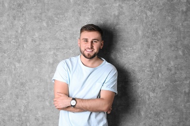 Photo of Portrait of handsome happy man on grey background