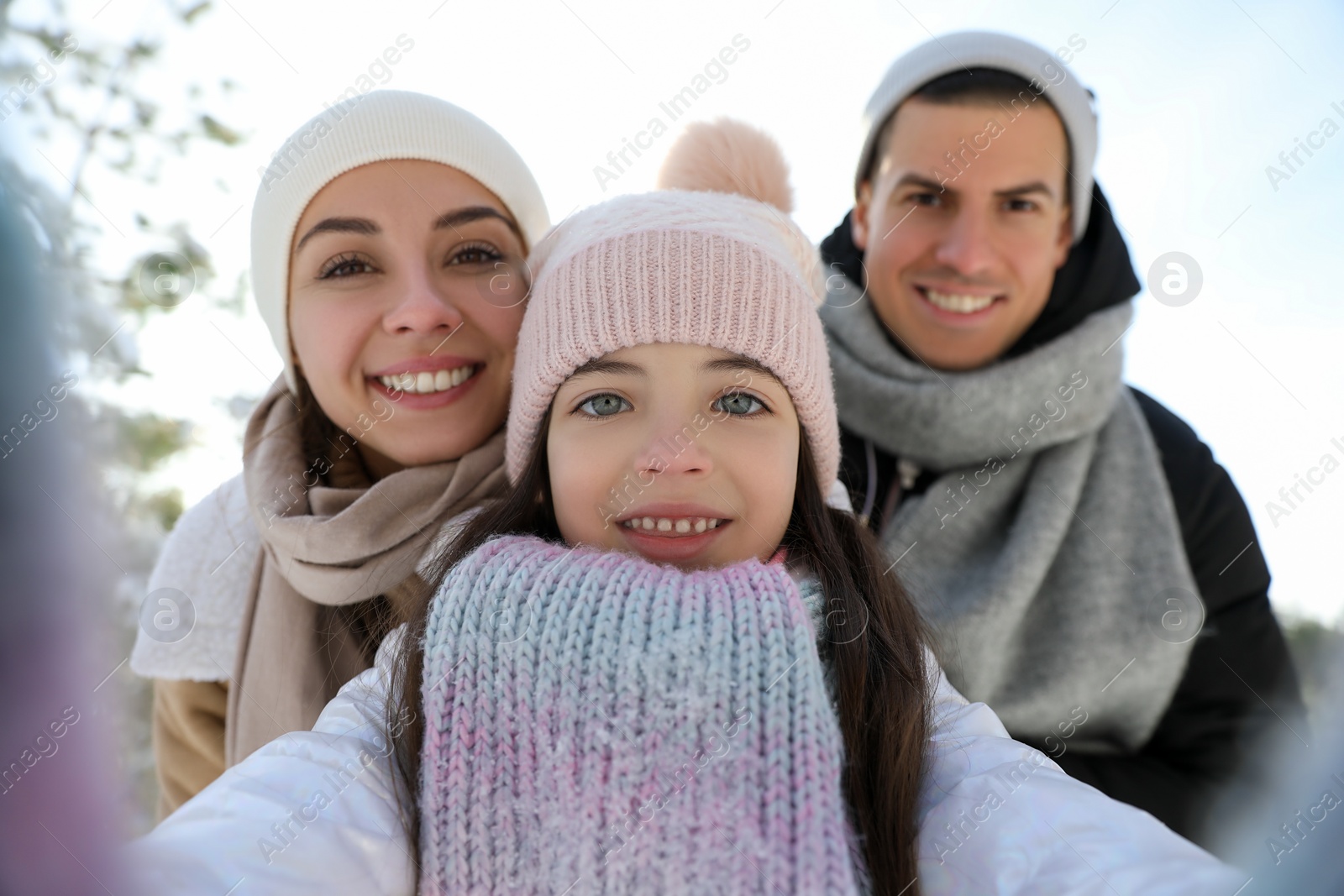 Photo of Happy family taking selfie outdoors on winter day. Christmas vacation