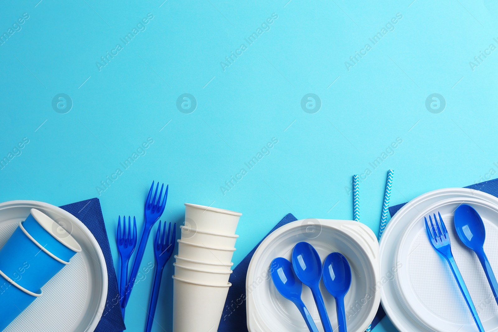 Photo of New plastic dishware and space for text on color background. Table setting