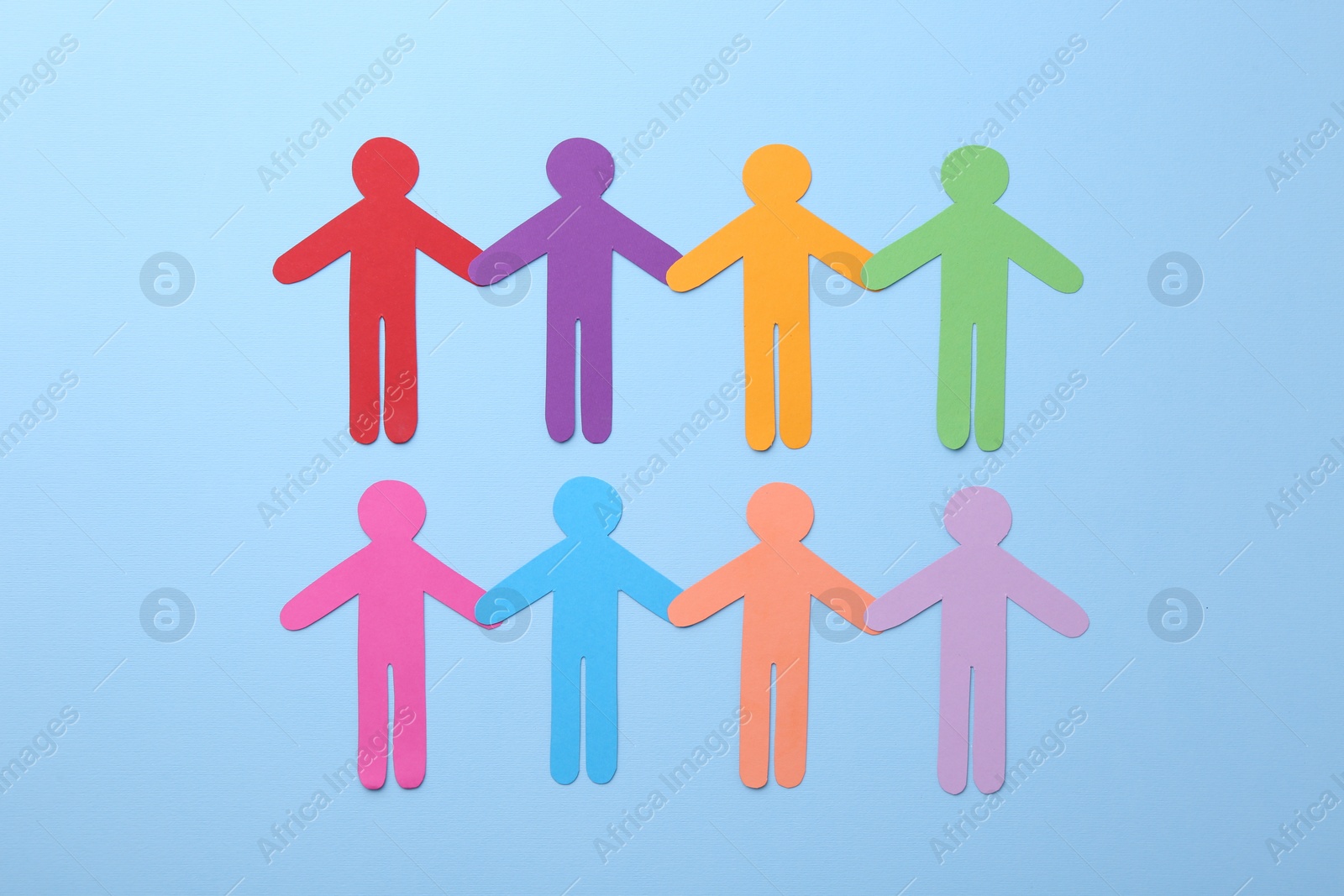 Photo of Equality concept. Different human figures on light blue background, flat lay