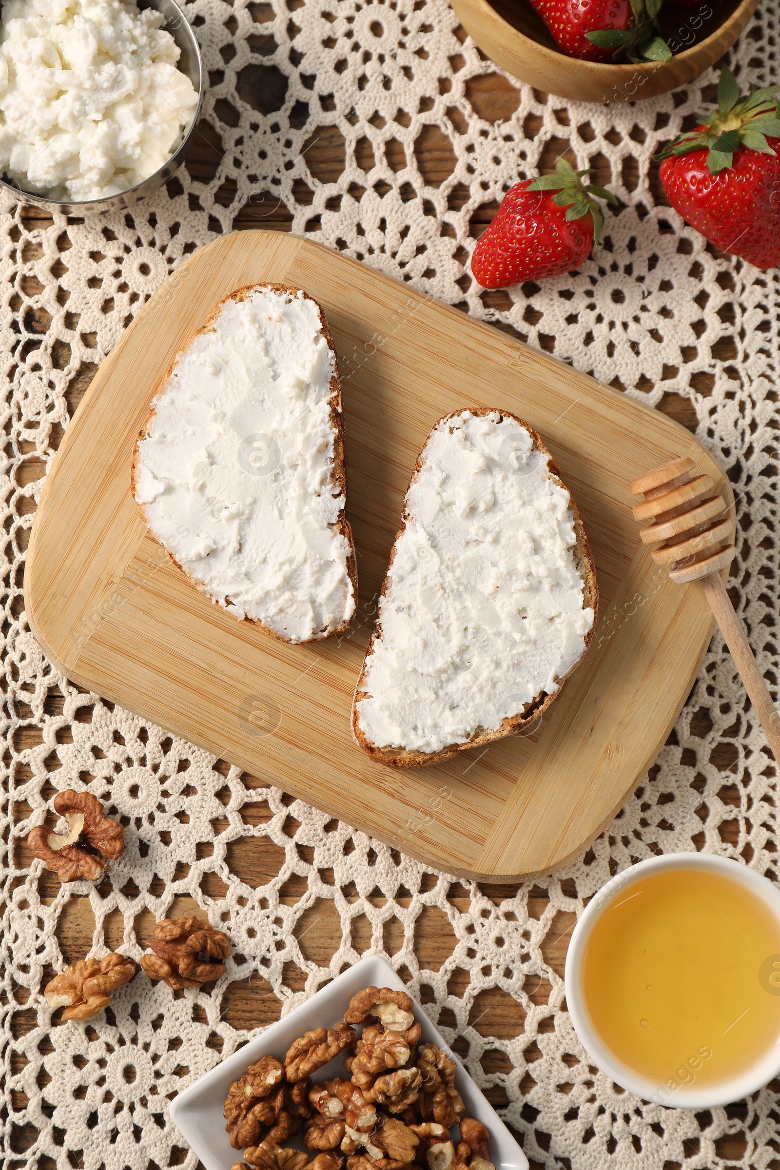 Photo of Delicious ricotta bruschettas and products on table, flat lay