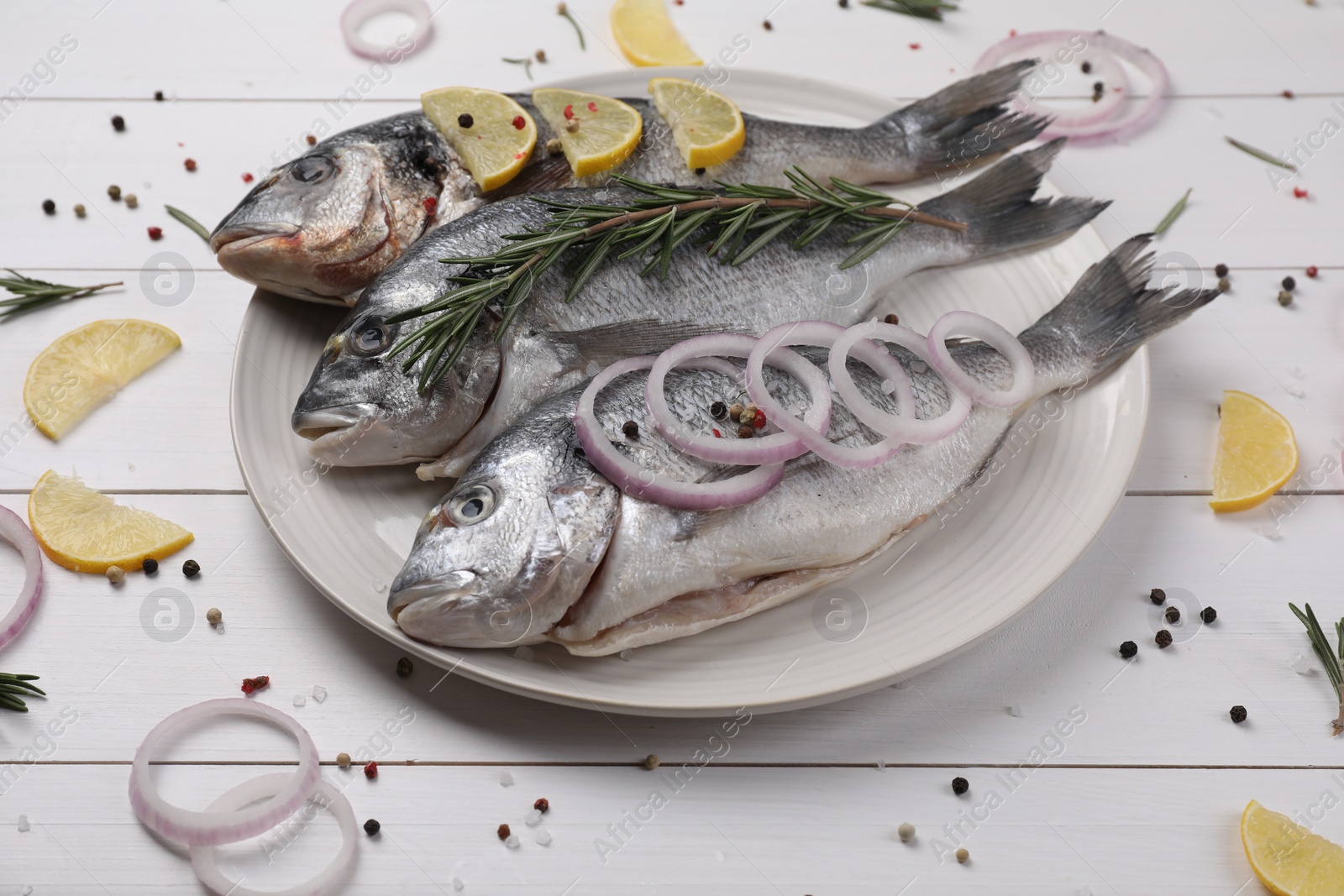 Photo of Composition with raw dorado fish and spices on white wooden table