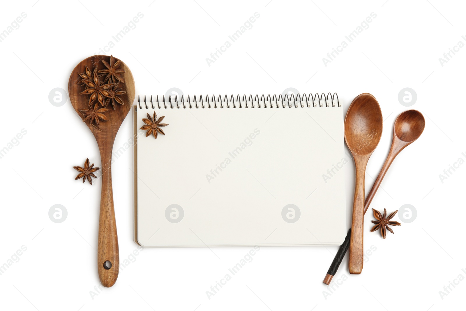 Photo of Blank recipe book, anise stars and wooden spoons on white background, top view. Space for text