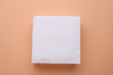 Photo of Stack of clean paper tissues on beige background, top view