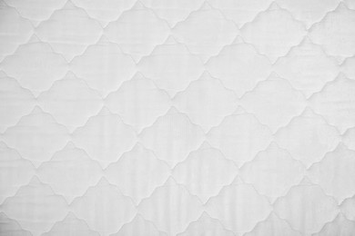 Photo of Comfortable orthopedic mattress as background, top view