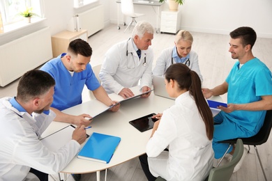 Photo of Group of doctors attending meeting in clinic. Cardiology conference