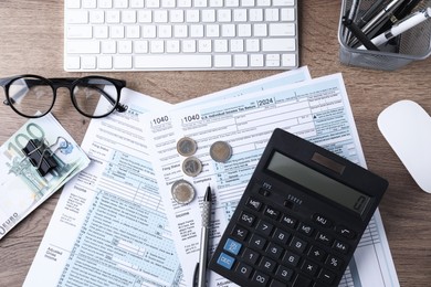 Photo of Tax accounting. Flat lay composition with calculator and documents on wooden table