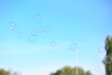 Beautiful translucent soap bubbles outdoors on sunny day