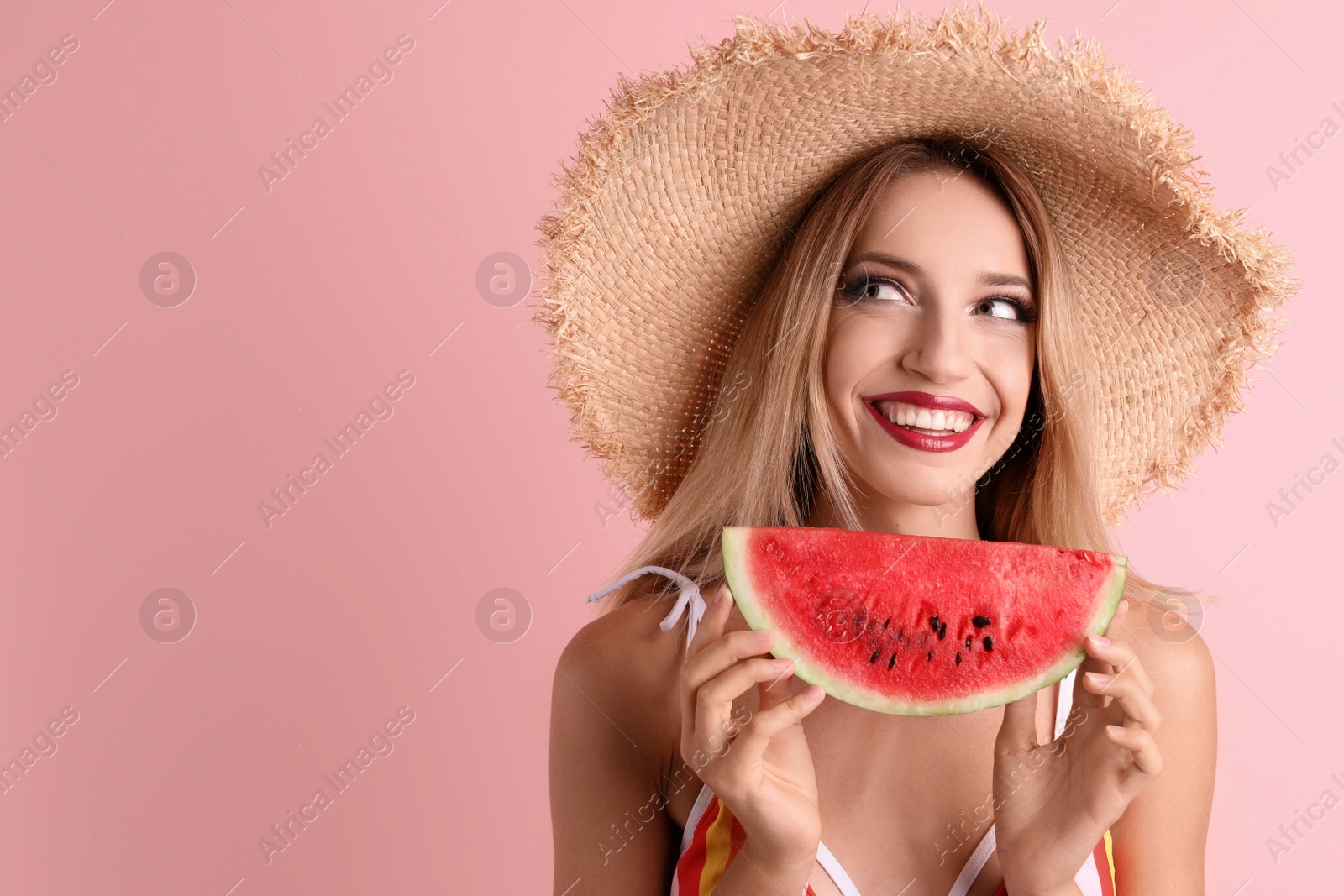 Photo of Pretty young woman with juicy watermelon on color background