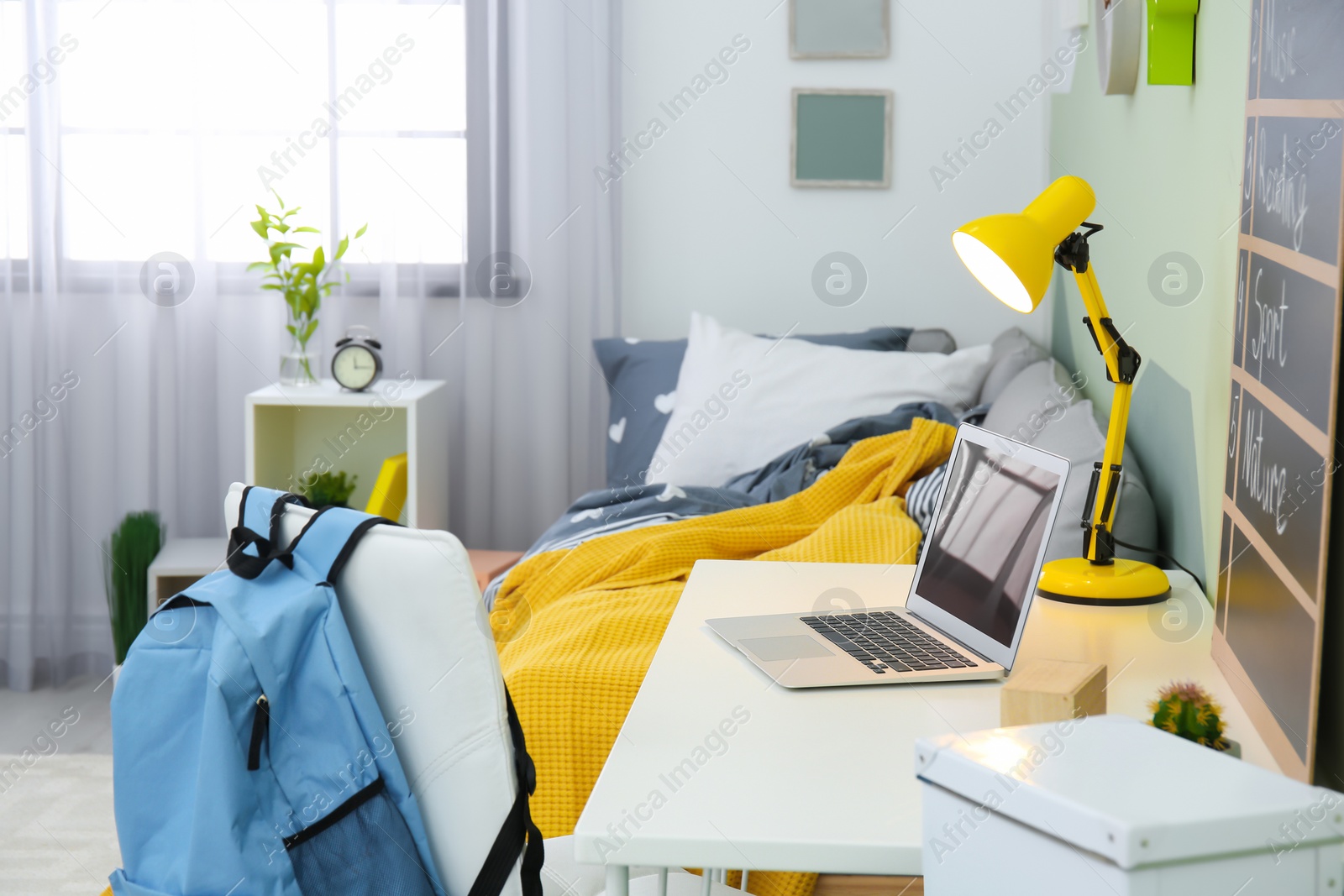 Photo of Modern child room interior with desk and laptop