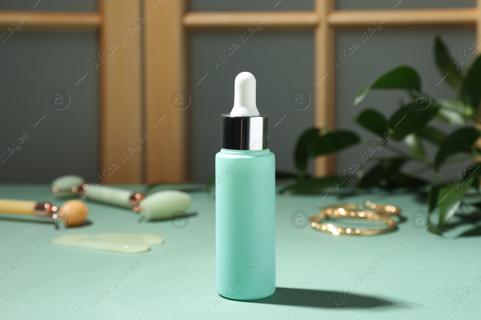 Photo of Bottle of cosmetic product on light blue table